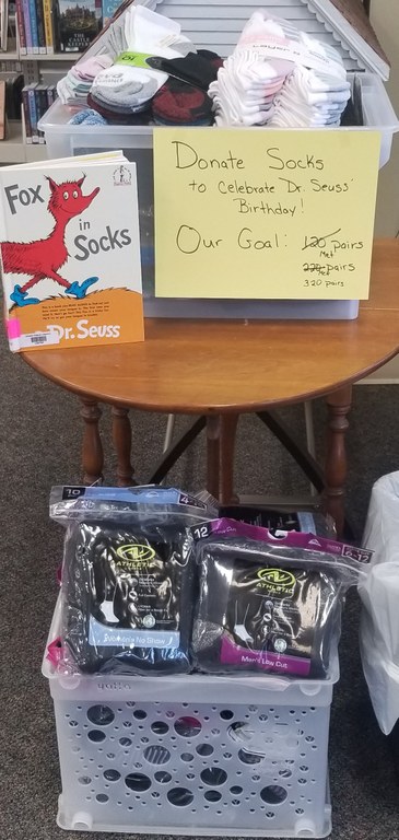 Socks donated by patrons on table and in crate